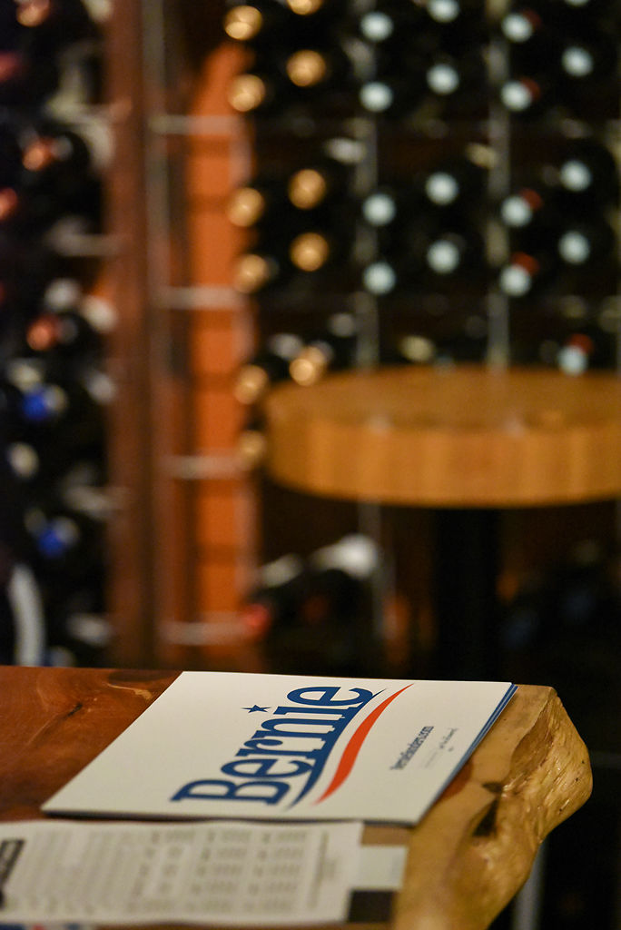 A Bernie Sanders sign sits next to a volunteer sign up sheet during the Bernie Sanders Democratic debate watch party